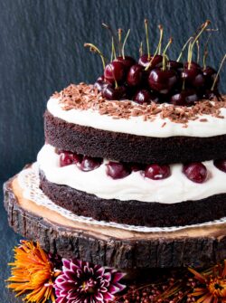 Easy Homemade Black Forest Cake - moist decadent chocolate cake surrounded by whipped cream and juicy black cherries. #blackforestcake #easyblackforestcake #blackforestgateau