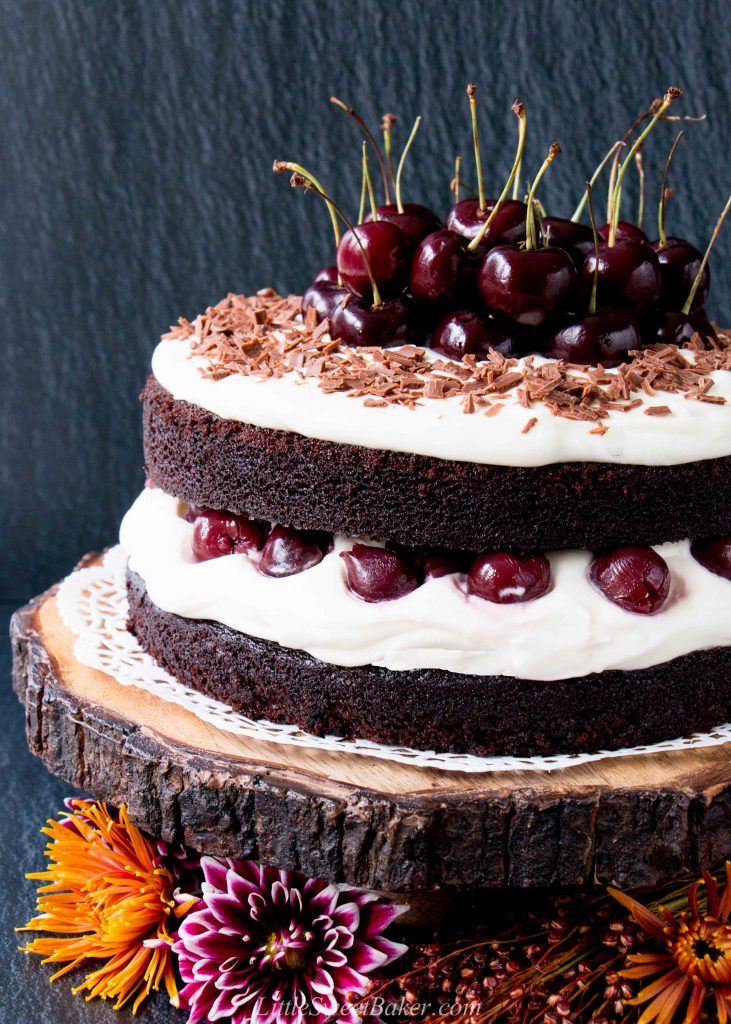 Easy Homemade Black Forest Cake - moist decadent chocolate cake surrounded by whipped cream and juicy black cherries. #blackforestcake #easyblackforestcake #blackforestgateau