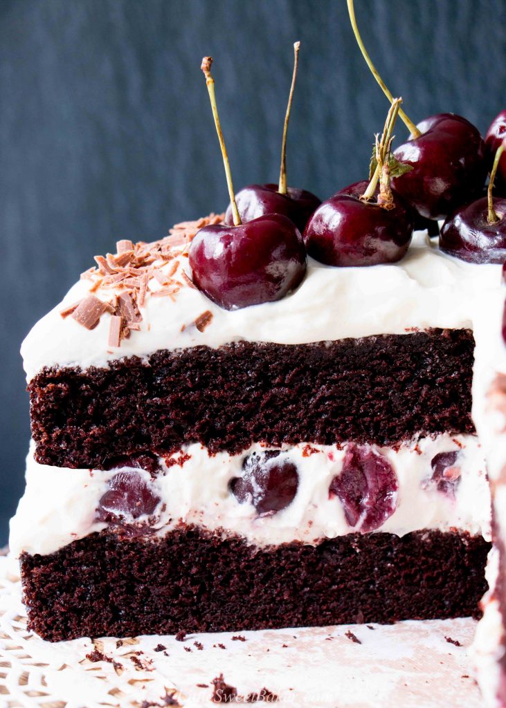 Easy Homemade Black Forest Cake - moist decadent chocolate cake surrounded by whipped cream and juicy black cherries. #blackforestcake #easyblackforestcake #blackforestgateau