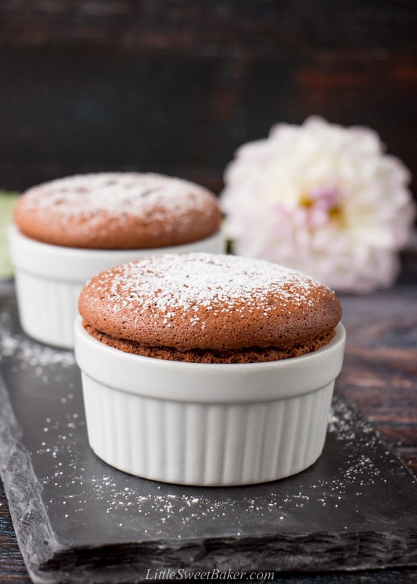 Two chocolate souffles on a piece of black slate.