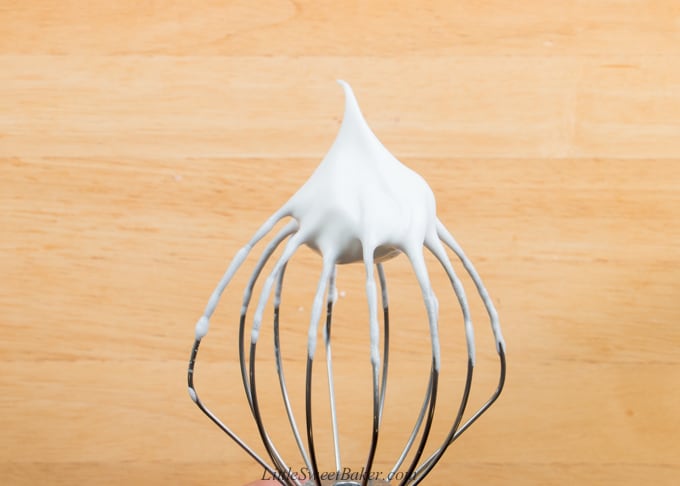 a whisk attachment showing egg whites beaten to stiff peaks