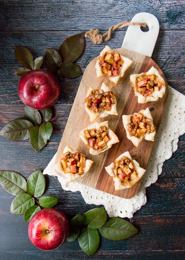 A cross between sweet and savory, these apple tartlets are wrapped in a flaky puff pastry and filled with apples, creamy brie and walnuts. #appletartlets #miniappletarts #appleandcheese #appetizer #snack