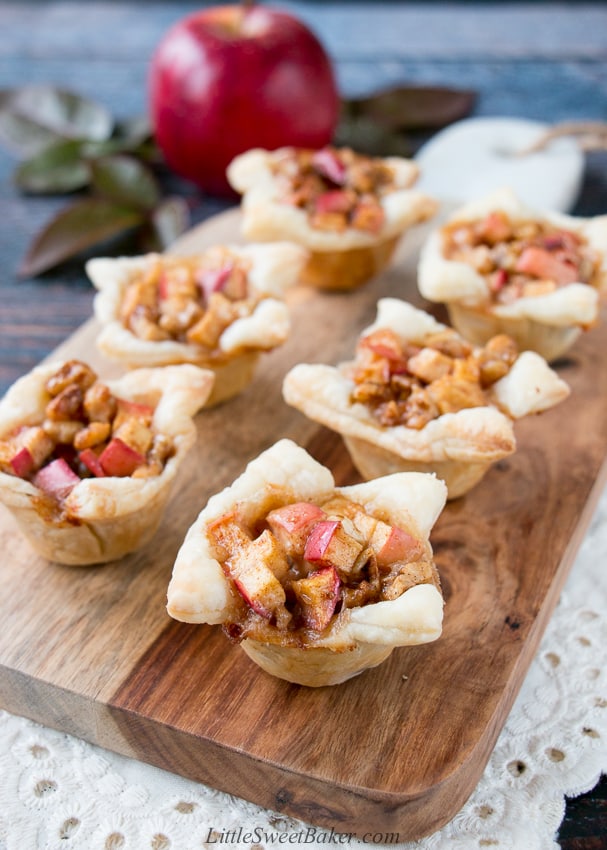 A cross between sweet and savory, these apple tartlets are wrapped in a flaky puff pastry and filled with apples, creamy brie and walnuts. #appletartlets #miniappletarts #appleandcheese #appetizer #snack