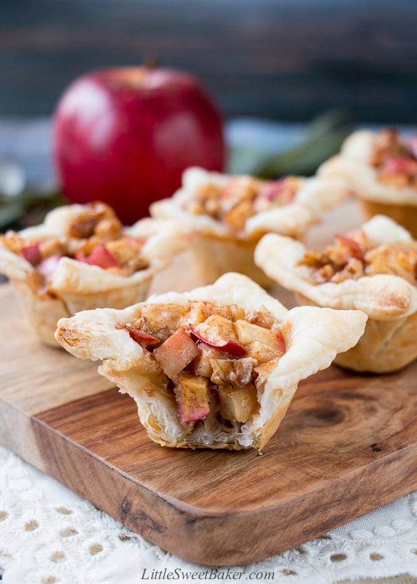 A cross between sweet and savory, these apple tartlets are wrapped in a flaky puff pastry and filled with apples, creamy brie and walnuts. #appletartlets #miniappletarts #appleandcheese #appetizer #snack