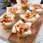 A cross between sweet and savory, these apple tartlets are wrapped in a flaky puff pastry and filled with apples, creamy brie and walnuts. #appletartlets #miniappletarts #appleandcheese #appetizer #snack