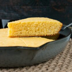 This one-bowl recipe for tender and buttery cornbread is baked in a cast iron skillet for a delightfully crispy crust. #cornbreadrecipe #skilletcornbread #buttermilkcornbread #castironcornbread