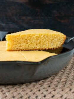 This one-bowl recipe for tender and buttery cornbread is baked in a cast iron skillet for a delightfully crispy crust. #cornbreadrecipe #skilletcornbread #buttermilkcornbread #castironcornbread
