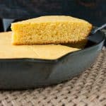 This one-bowl recipe for tender and buttery cornbread is baked in a cast iron skillet for a delightfully crispy crust. #cornbreadrecipe #skilletcornbread #buttermilkcornbread #castironcornbread