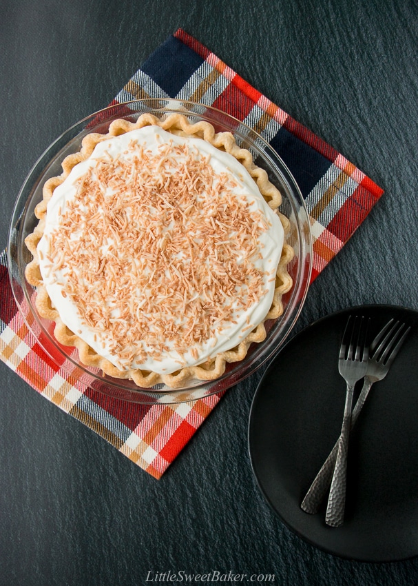 This homemade coconut cream pie is made with coconut milk and shredded coconut for the most flavorful and delicious custard filling you've ever tasted!#coconutcreampie #coconutmilk #flakypiecrust #Thanksgivingdessert