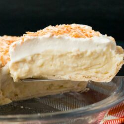This homemade coconut cream pie is made with coconut milk and shredded coconut for the most flavorful and delicious custard filling you've ever tasted!#coconutcreampie #coconutmilk #flakypiecrust #Thanksgivingdessert