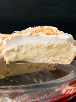 This homemade coconut cream pie is made with coconut milk and shredded coconut for the most flavorful and delicious custard filling you've ever tasted!#coconutcreampie #coconutmilk #flakypiecrust #Thanksgivingdessert