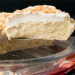 This homemade coconut cream pie is made with coconut milk and shredded coconut for the most flavorful and delicious custard filling you've ever tasted!#coconutcreampie #coconutmilk #flakypiecrust #Thanksgivingdessert