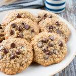 These cookies are crispy on the edges, soft in the middle, and loaded with chocolate chips. They are a perfect mix of decadent chocolate chip cookies and wholesome oatmeal cookies. #oatmealchocolatechipcookies #recipe