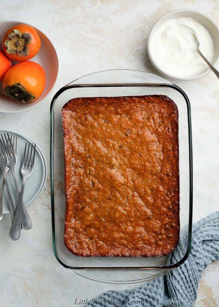 Persimmon pudding in a glass casserole dish.