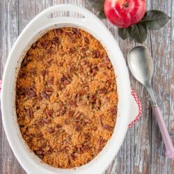 This wonderful casserole side dish is both sweet and savory. It's filled with tender chunks of apples and butternut squash, and it's topped with a buttery and crunchy pecan crumble. #holidaysidedish #butternutsquashcasserole #Thanksgivingsidedish #Christmassidedish