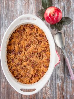 This wonderful casserole side dish is both sweet and savory. It's filled with tender chunks of apples and butternut squash, and it's topped with a buttery and crunchy pecan crumble. #holidaysidedish #butternutsquashcasserole #Thanksgivingsidedish #Christmassidedish