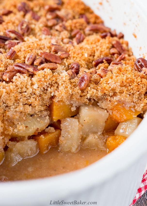 This wonderful casserole side dish is both sweet and savory. It's filled with tender chunks of apples and butternut squash, and it's topped with a buttery and crunchy pecan crumble. #holidaysidedish #butternutsquashcasserole #Thanksgivingsidedish #Christmassidedish