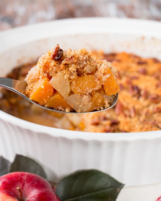 This wonderful casserole side dish is both sweet and savory. It's filled with tender chunks of apples and butternut squash, and it's topped with a buttery and crunchy pecan crumble. #holidaysidedish #butternutsquashcasserole #Thanksgivingsidedish #Christmassidedish
