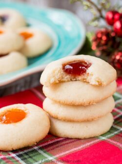 This classic holiday cookies is buttery and chewy with a delicious pocket of jam. #thumbprintcookies #Christmascookies #recipe #sugarcookie