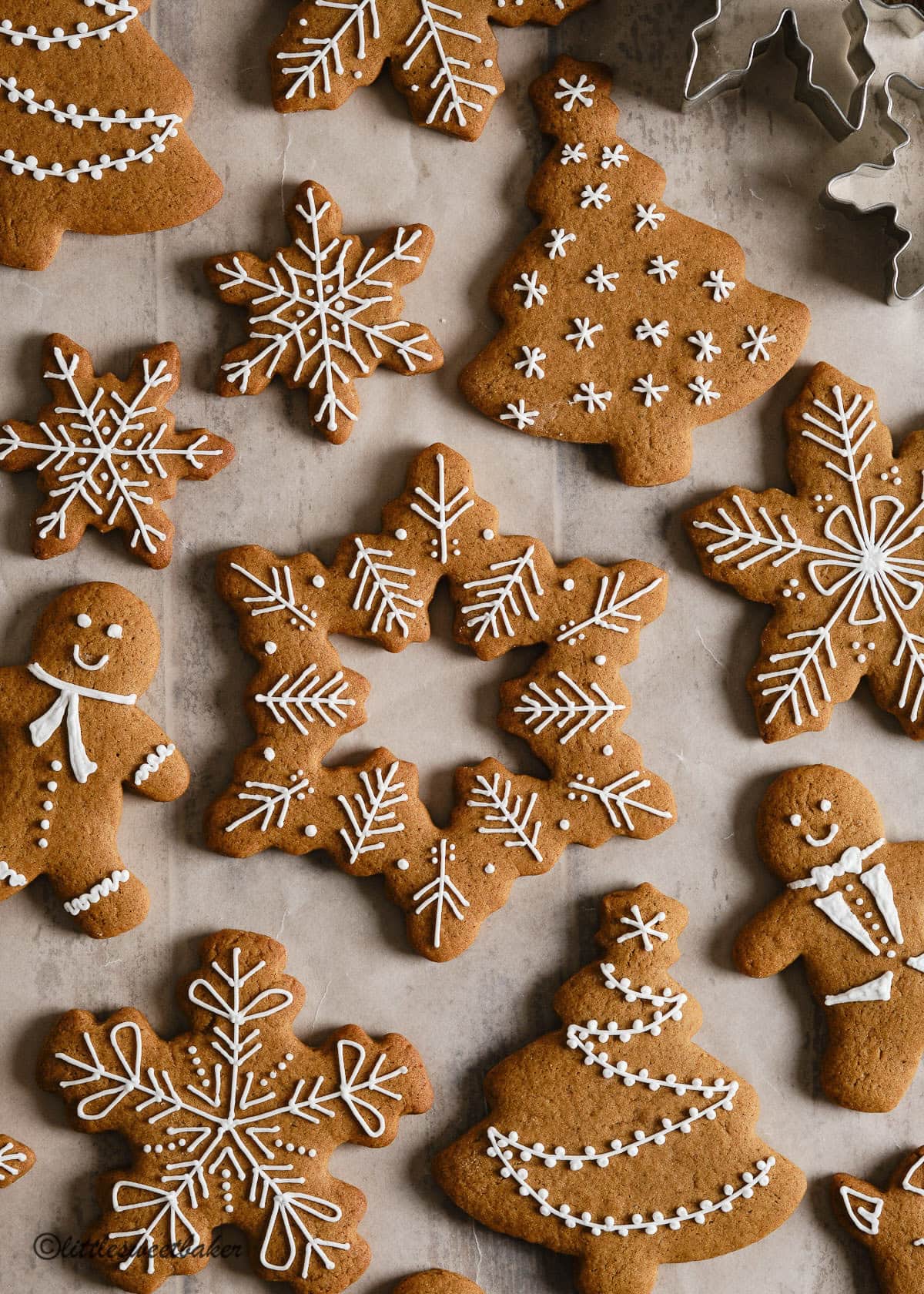 Decorated soft gingerbread cookies on parchment paper.