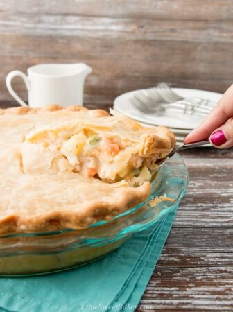 slice of chicken pot pie being lifted from whole pie