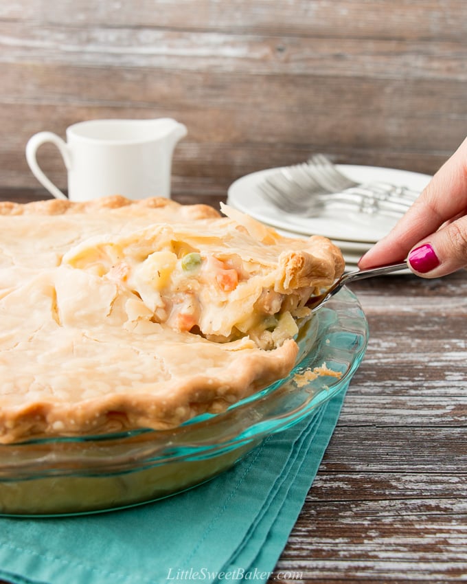 slice of chicken pot pie being lifted from whole pie