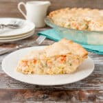 This chicken pot pie is made with a flaky pie crust filled with a creamy sauce that is loaded with chicken, potatoes and veggies. #chickenpotpie #easychickenpotpie #recipe #comfortfood