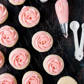 soft frosted sugar cookies on a cooling rack