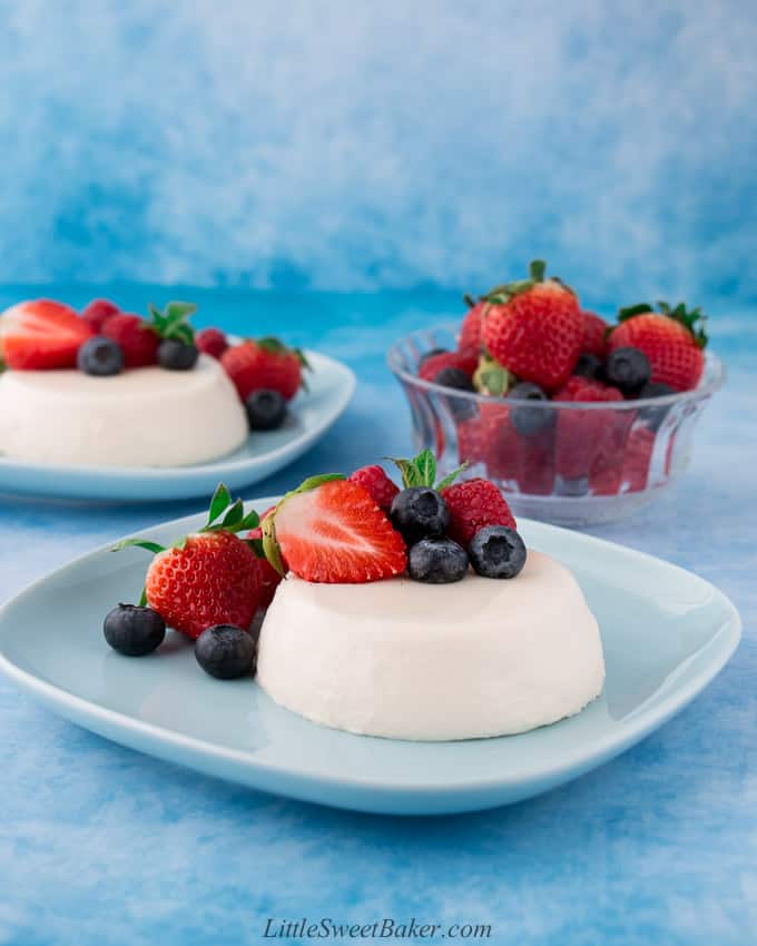 panna cotta with berries on a blue plate