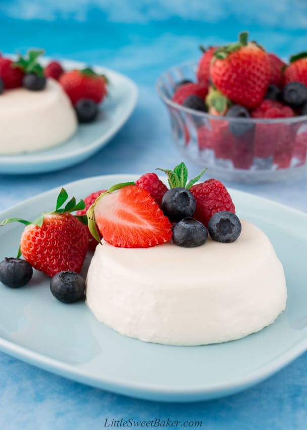 panna cotta with berries on a blue plate