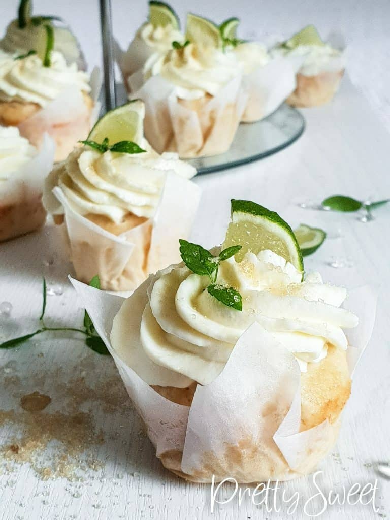 mojito cupcakes with white liners topped with lime and mint