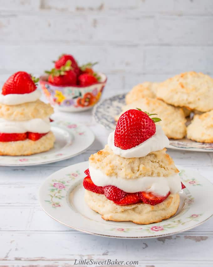 Strawberry shortcakes on vintage plates with white background.