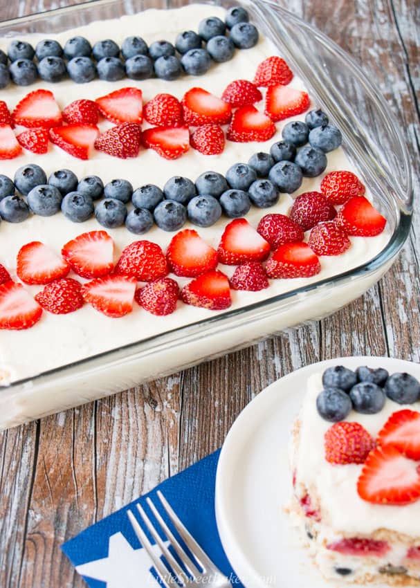 A 4th of July icebox cake with a slice on a white plate in the corner.