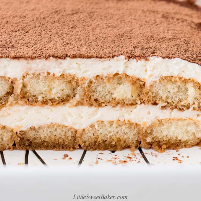 a cross section of tiramisu in a white baking pan