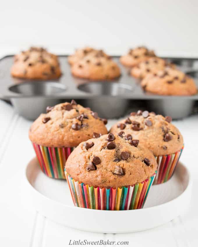 A white plate with three banana chocolate chip muffins.