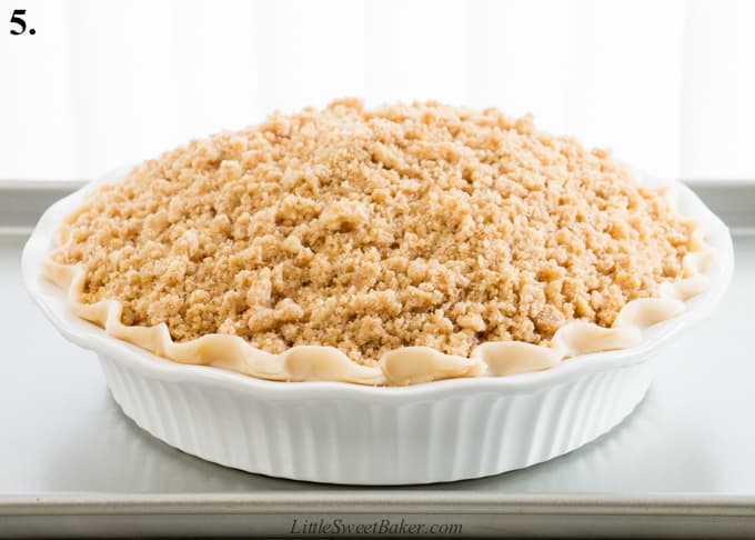 An unbaked Dutch apple pie on a baking sheet.