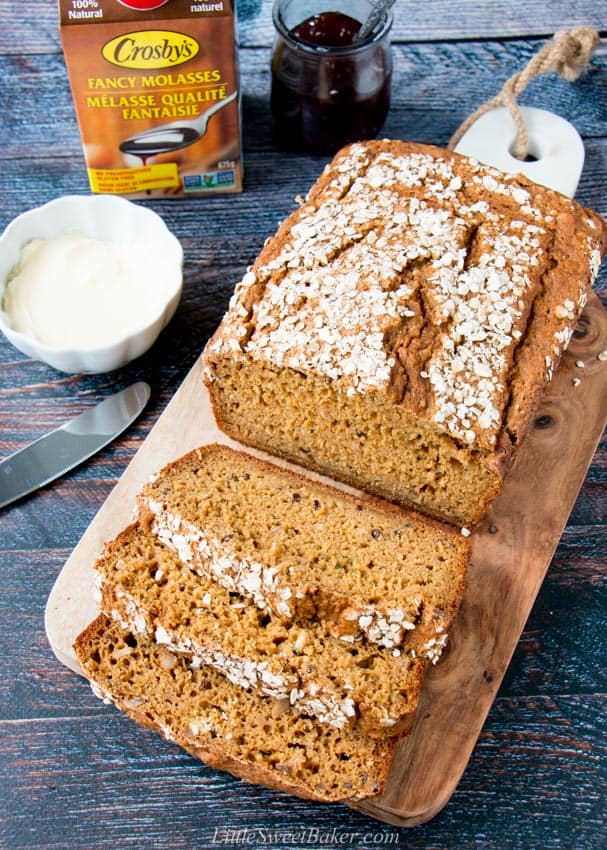 An overhead view of a loaf of quick brown bread on a cutting board.