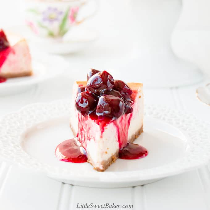 A slice of cherry cheesecake on a white plate.