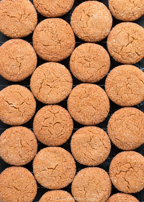 An overhead view of ginger snap cookies on a cooling rack.