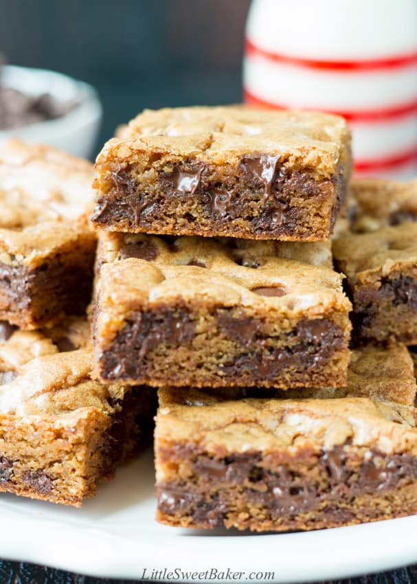 A stack of chocolate chip cookie bars on a white plate.