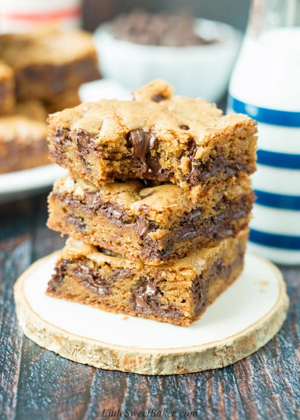 A stack of chocolate chip cookie bars with a bite taken out of the top one.