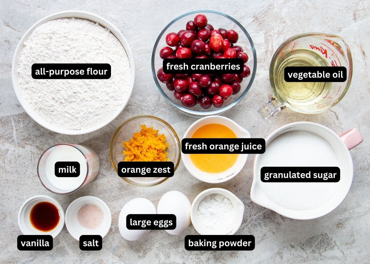 A labelled image of ingredients needed to make cranberry orange muffins.