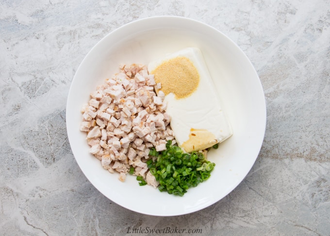 Ingredients for turkey rangoon in a white mixing bowl.