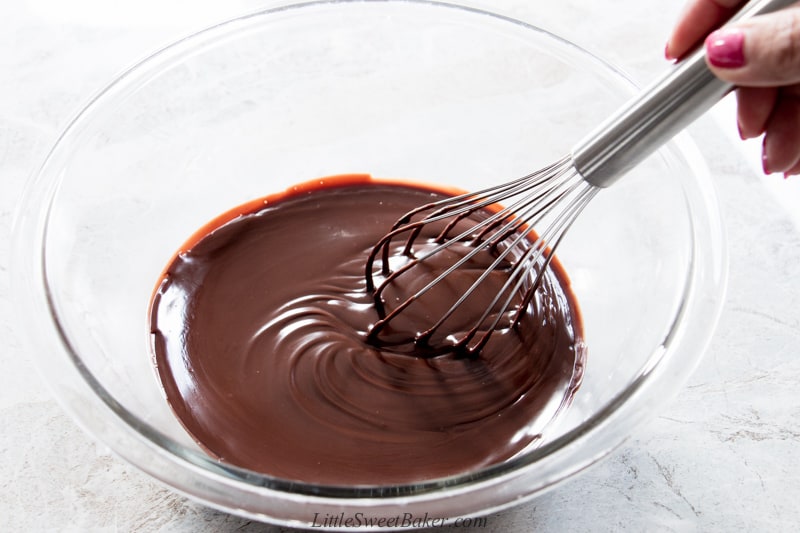 a bowl of chocolate ganache being smoothly whisked