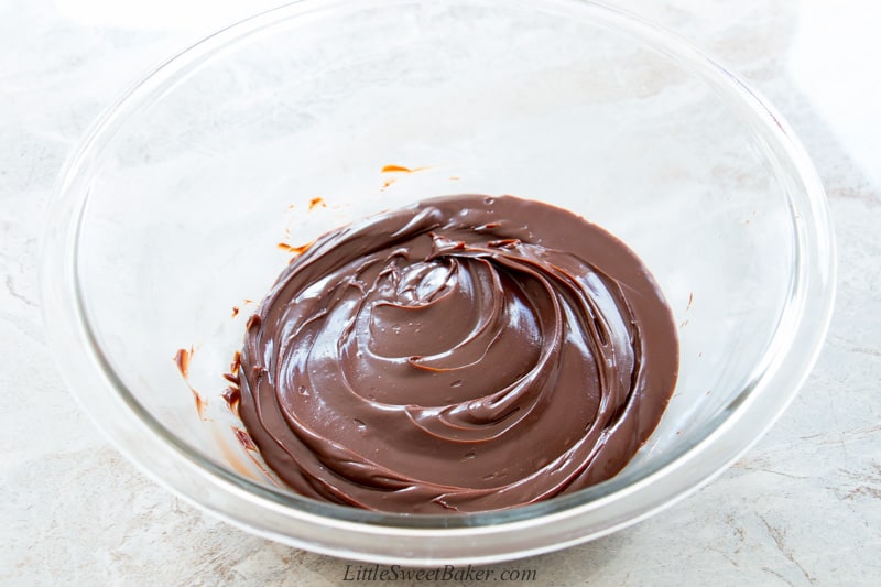 A glass bowl of smooth chocolate ganache.