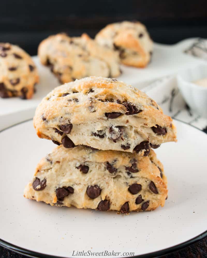 two chocolate chip scones stacked on a white plate