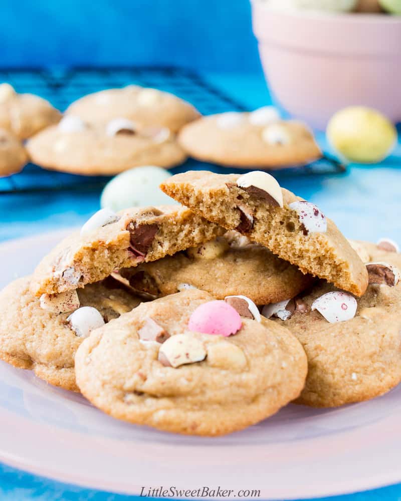A plate on mini egg cookies with one broken in half.