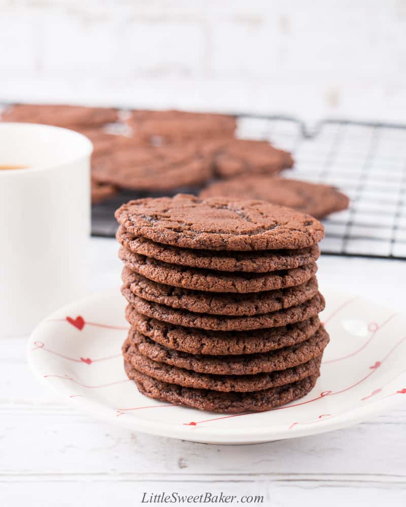 A stack of nutella cookies on a white plate with hearts.