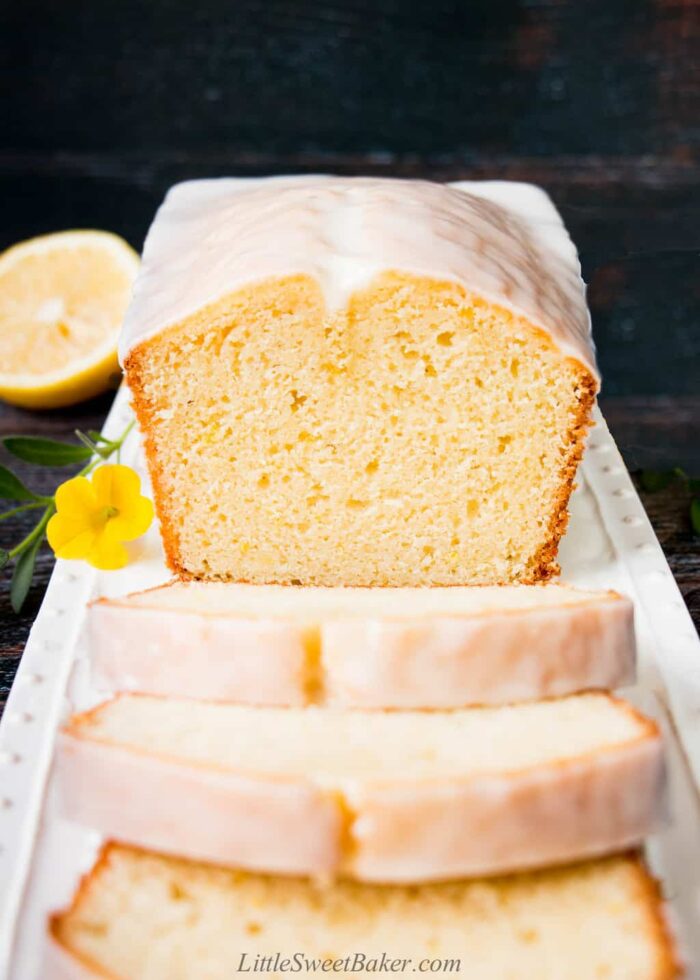 Lemon pound cake with lemon glaze on a white serving plate.