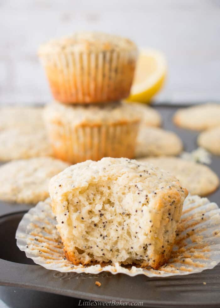 A lemon poppy seed muffin with a big bite taken out of it.